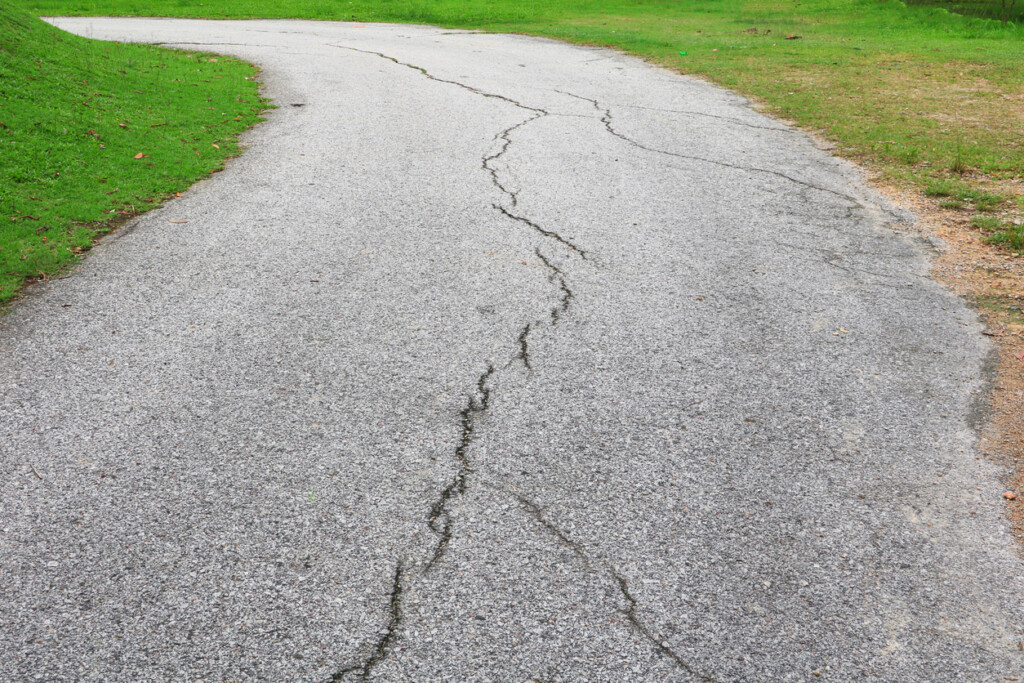 A cracked asphalt driveway.