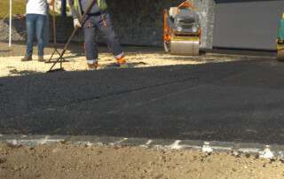 Partially asphalted and levelled fresh asphalt surface on the driveway